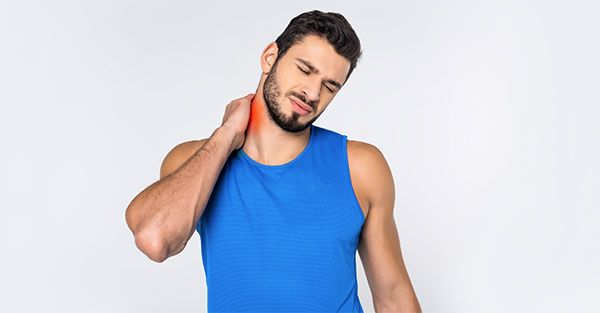 man holding neck in pain